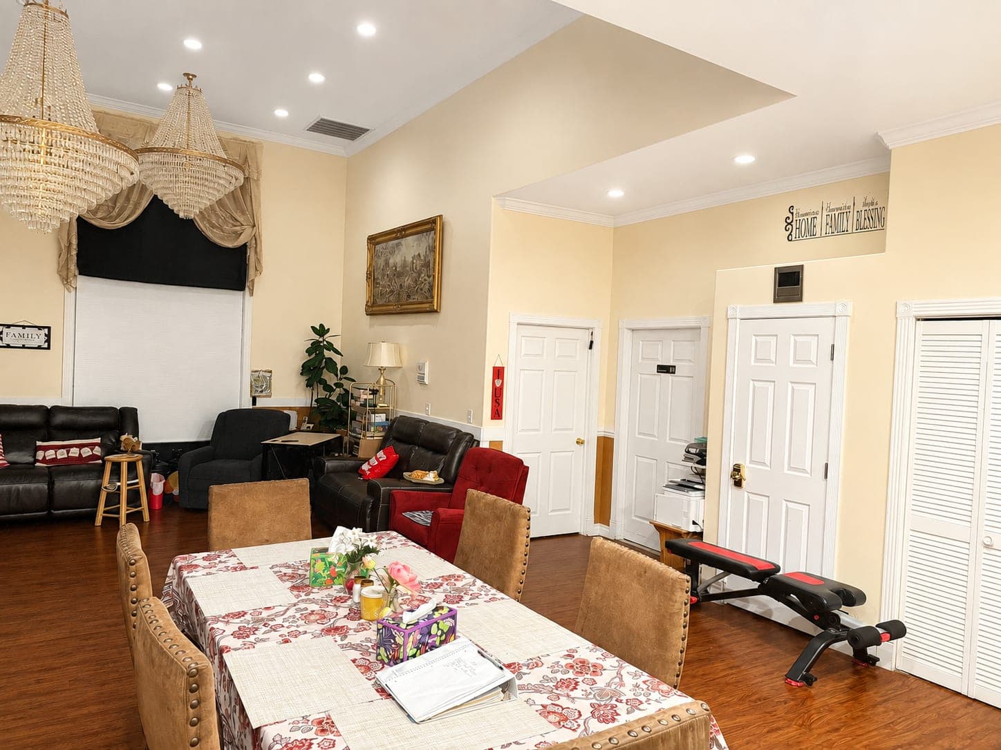 The open living and dining area, with the table laid, armchairs, and doors leading off to the bedrooms.